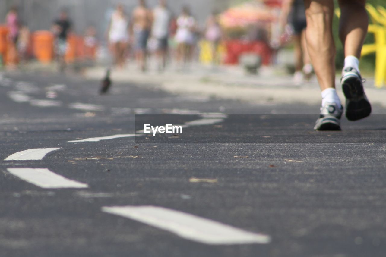 Low section of man running on road