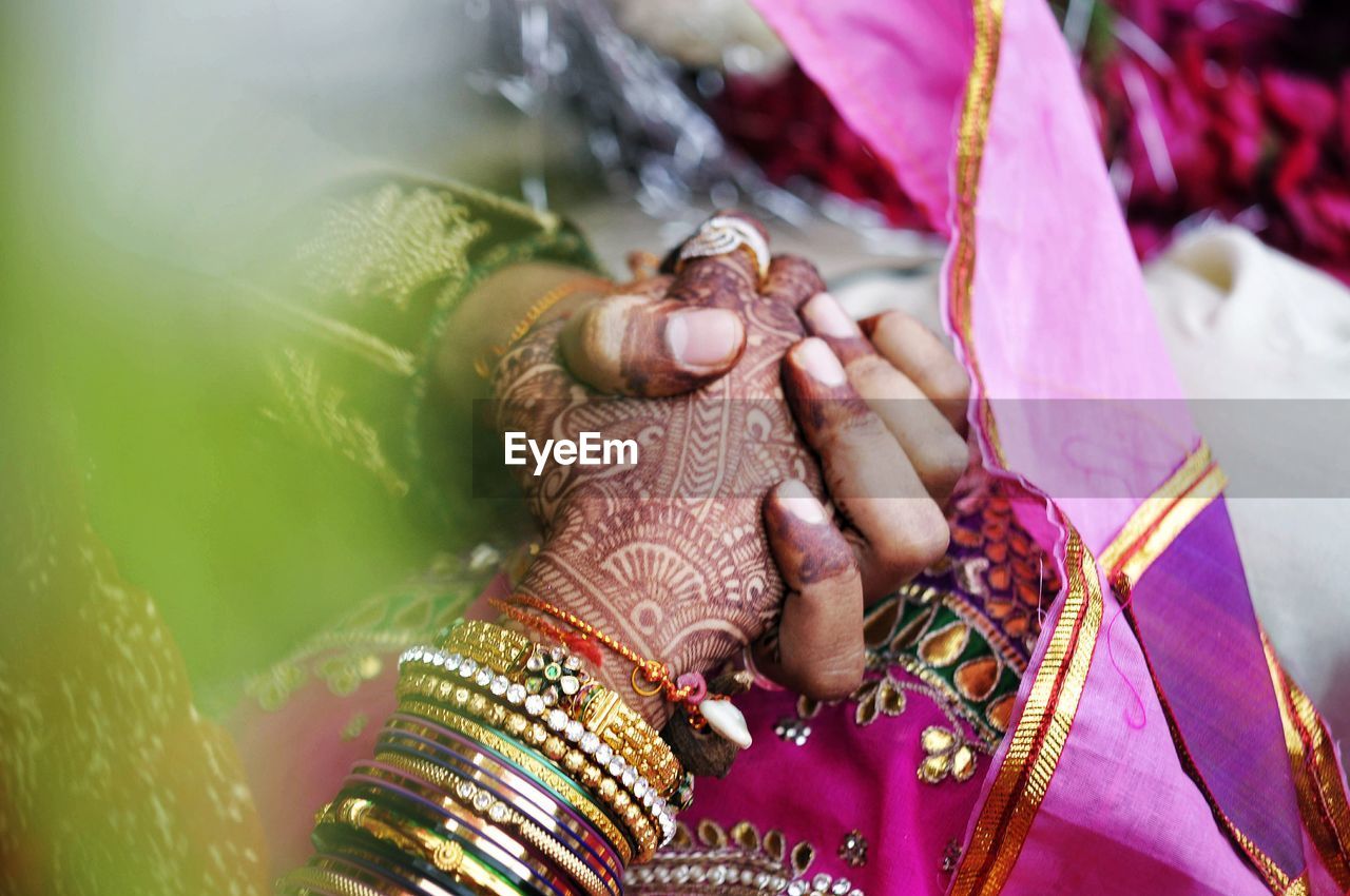 High angle view of couple holding hands during wedding ceremony