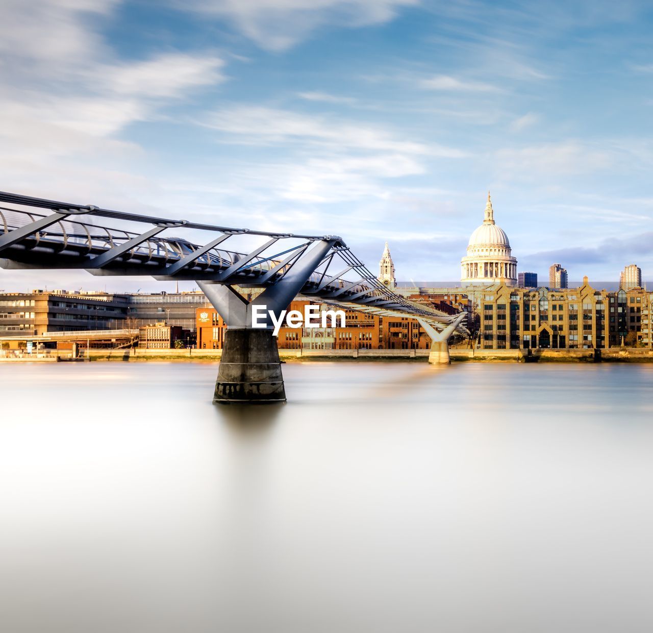 Bridge over river with city in background