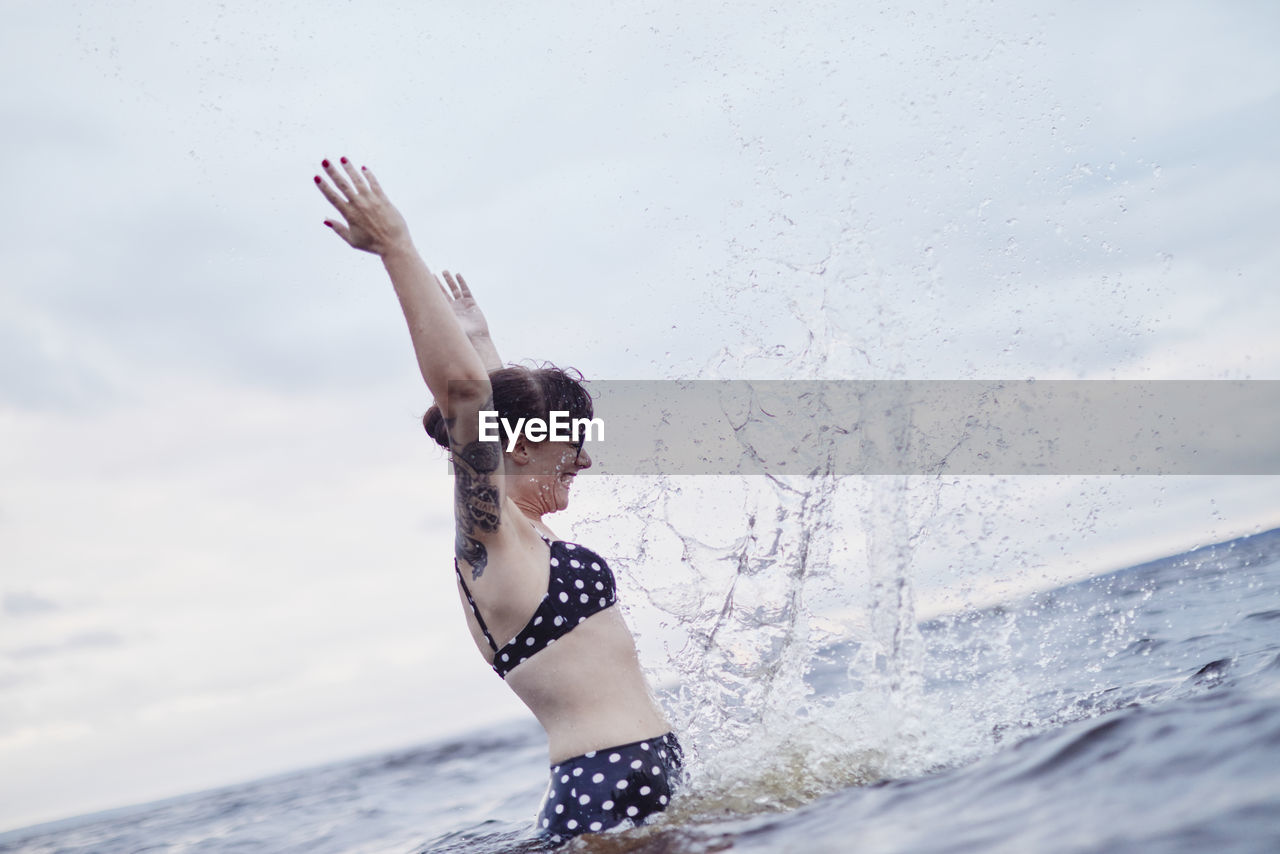 Woman splashing in sea