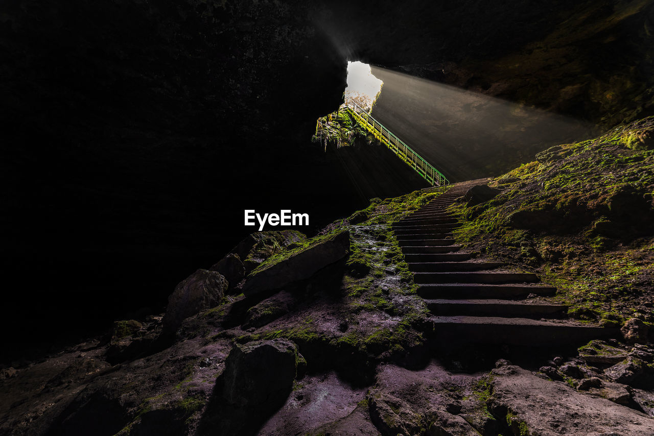 Staircase leading towards mountain at night