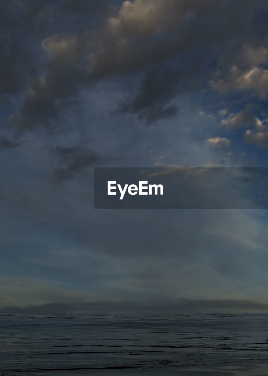 SCENIC VIEW OF BEACH AGAINST SKY AT SUNSET