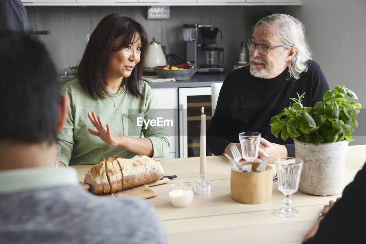 Family sitting at table and having conversation