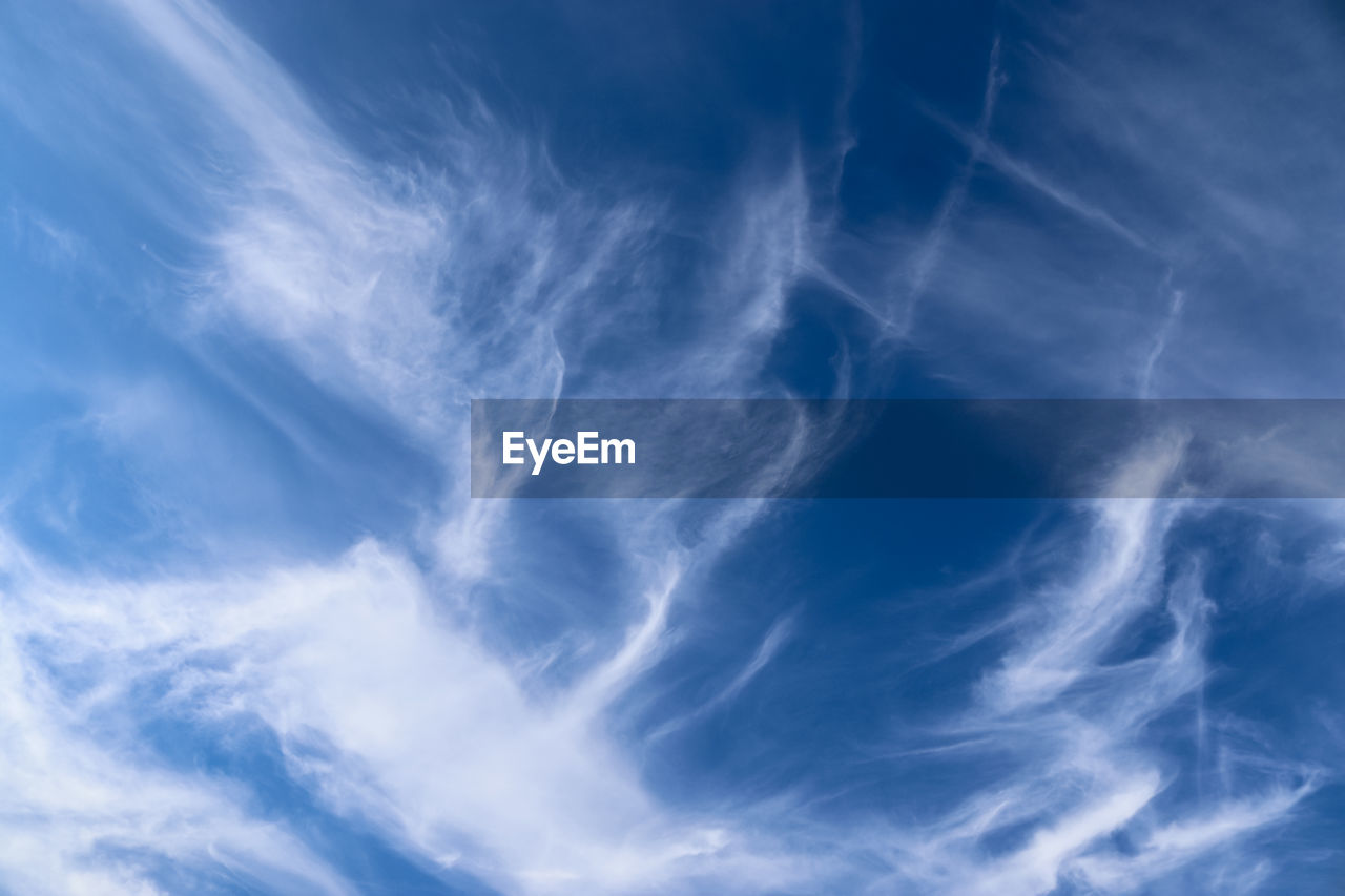 Stunning cirrus cloud formation panorama in a deep blue summer sky seen over europe