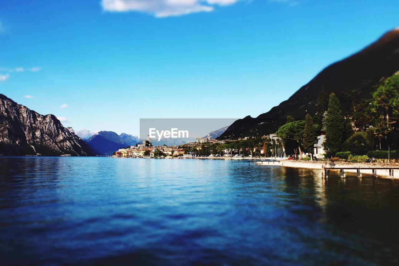 Scenic view of sea and mountains against clear blue sky