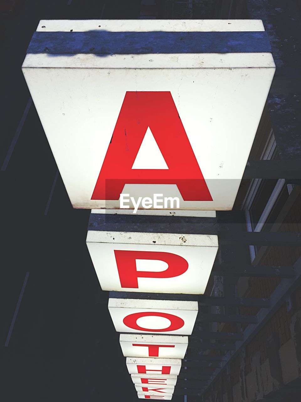 Illuminated pharmacy sign at night