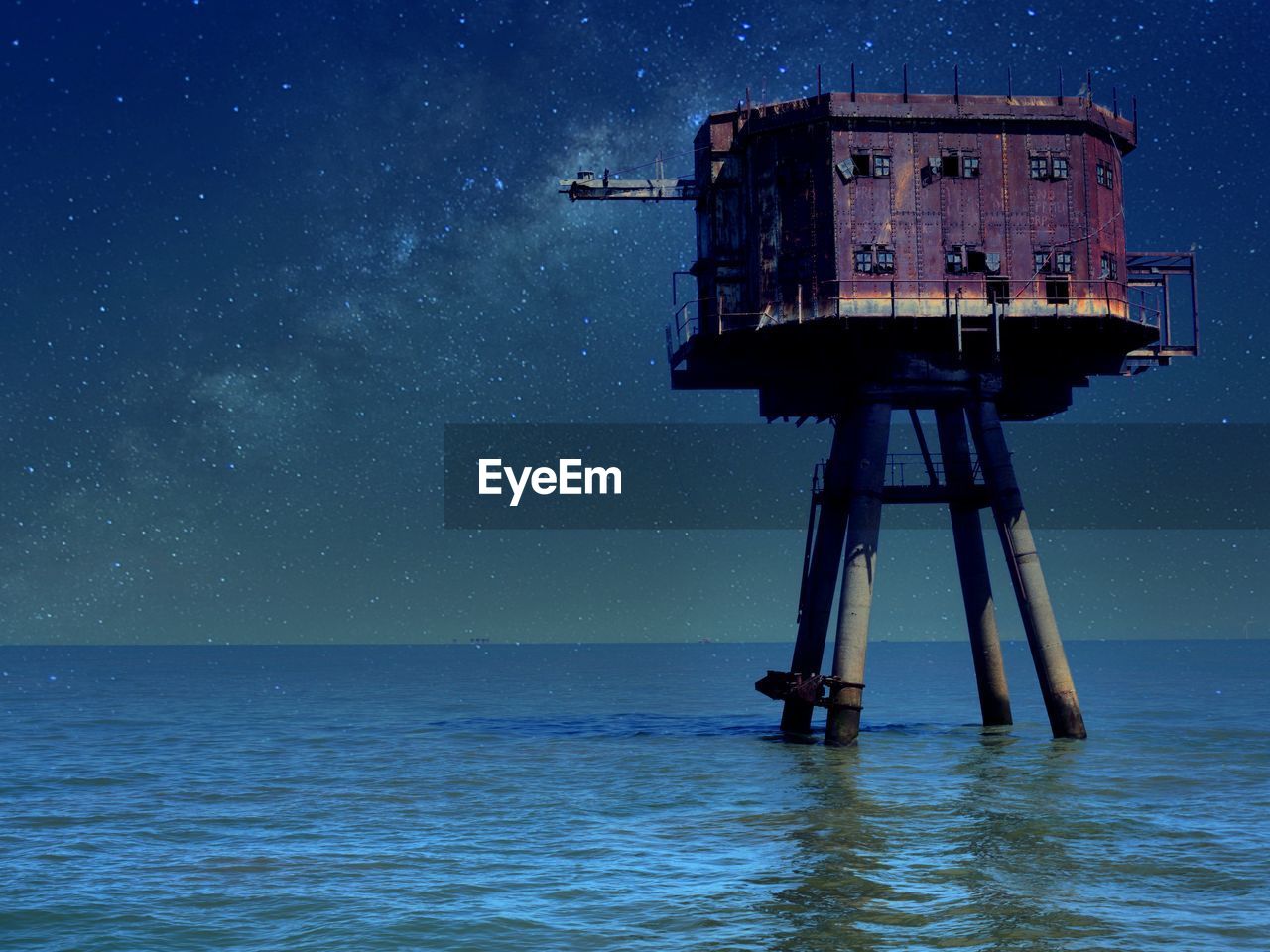 Scenic view of a seafort against sky at night