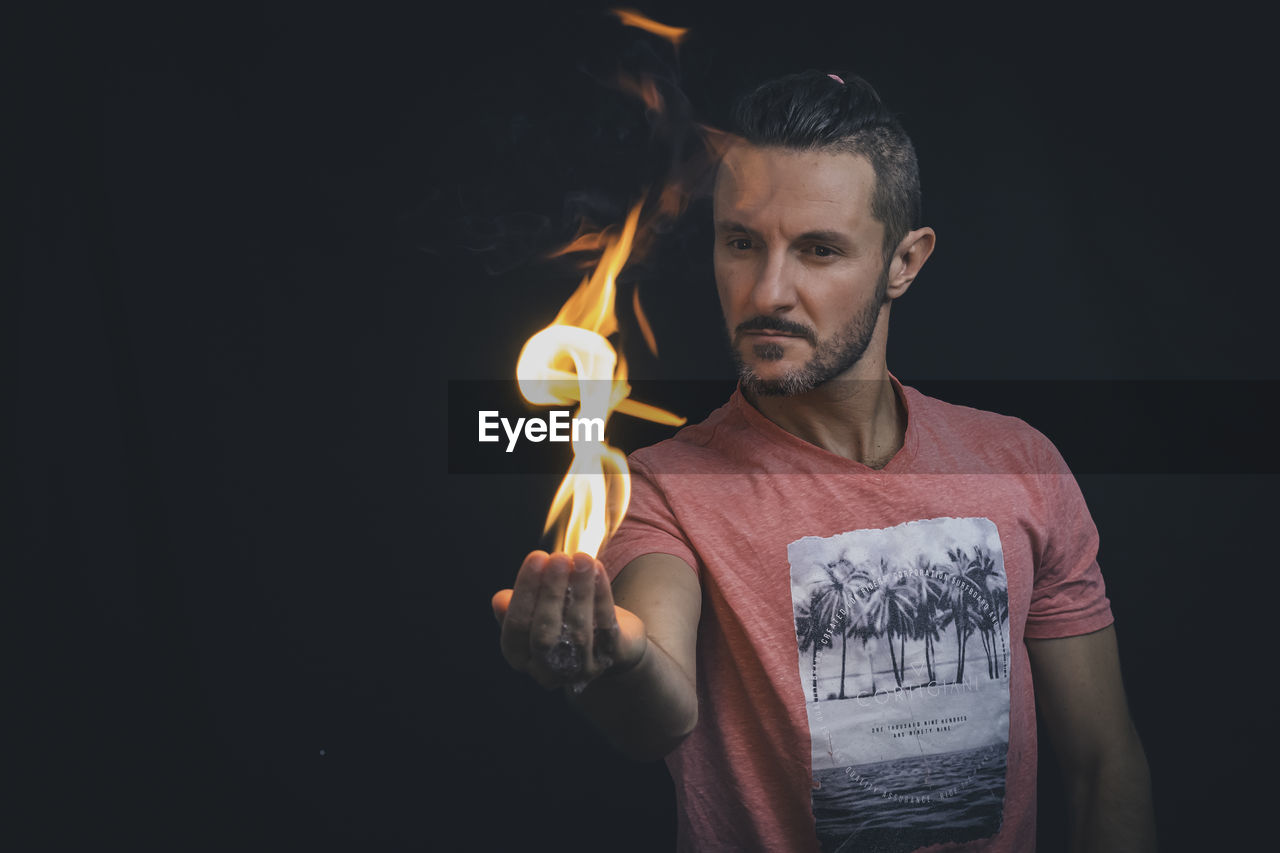 Man holding a fire in his hands. 