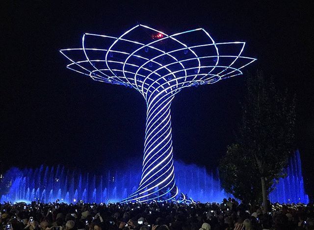 LOW ANGLE VIEW OF CROWD AGAINST SKY AT NIGHT