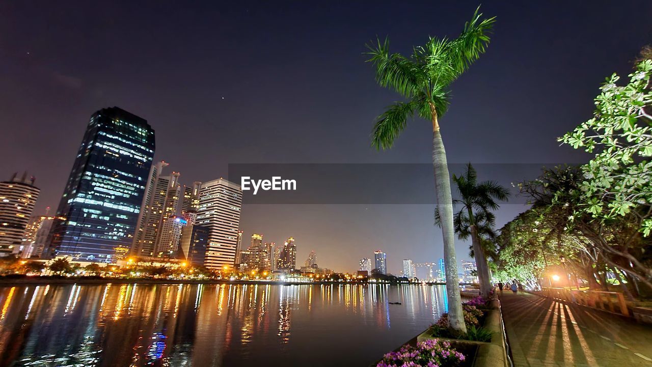 ILLUMINATED BUILDINGS AGAINST SKY AT NIGHT