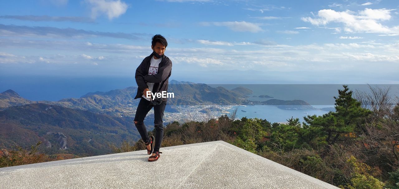 Full length of man standing against landscape