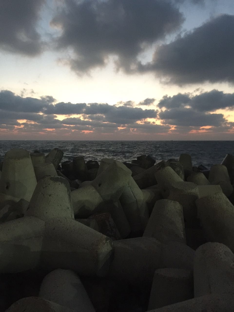 SCENIC VIEW OF BEACH AGAINST DRAMATIC SKY