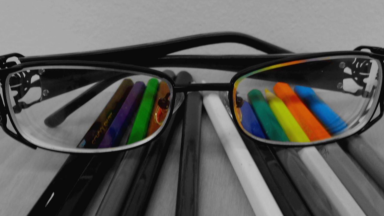 Eyeglasses on colored pencils