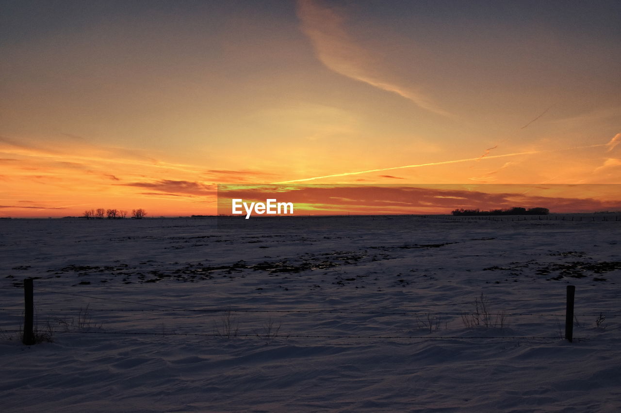 SCENIC VIEW OF BEACH DURING SUNSET