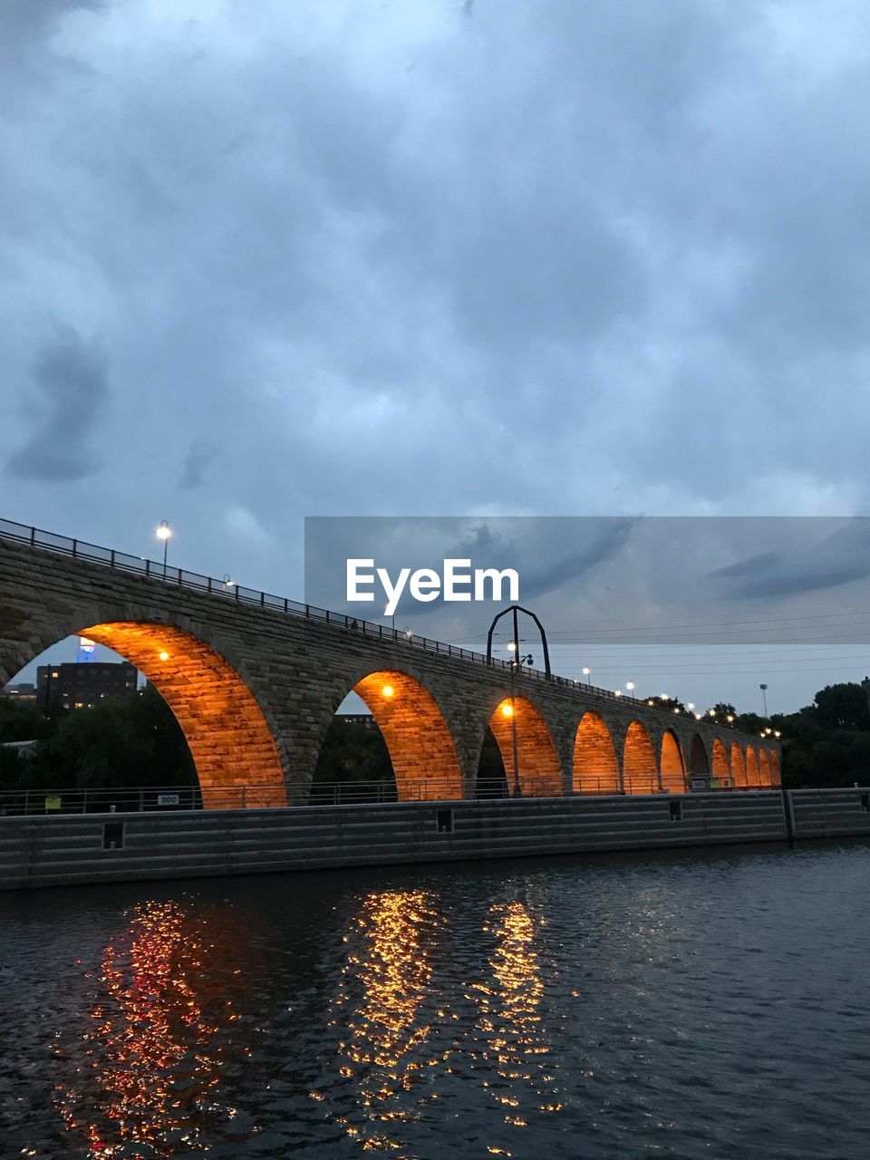 ARCH BRIDGE OVER RIVER AGAINST SKY