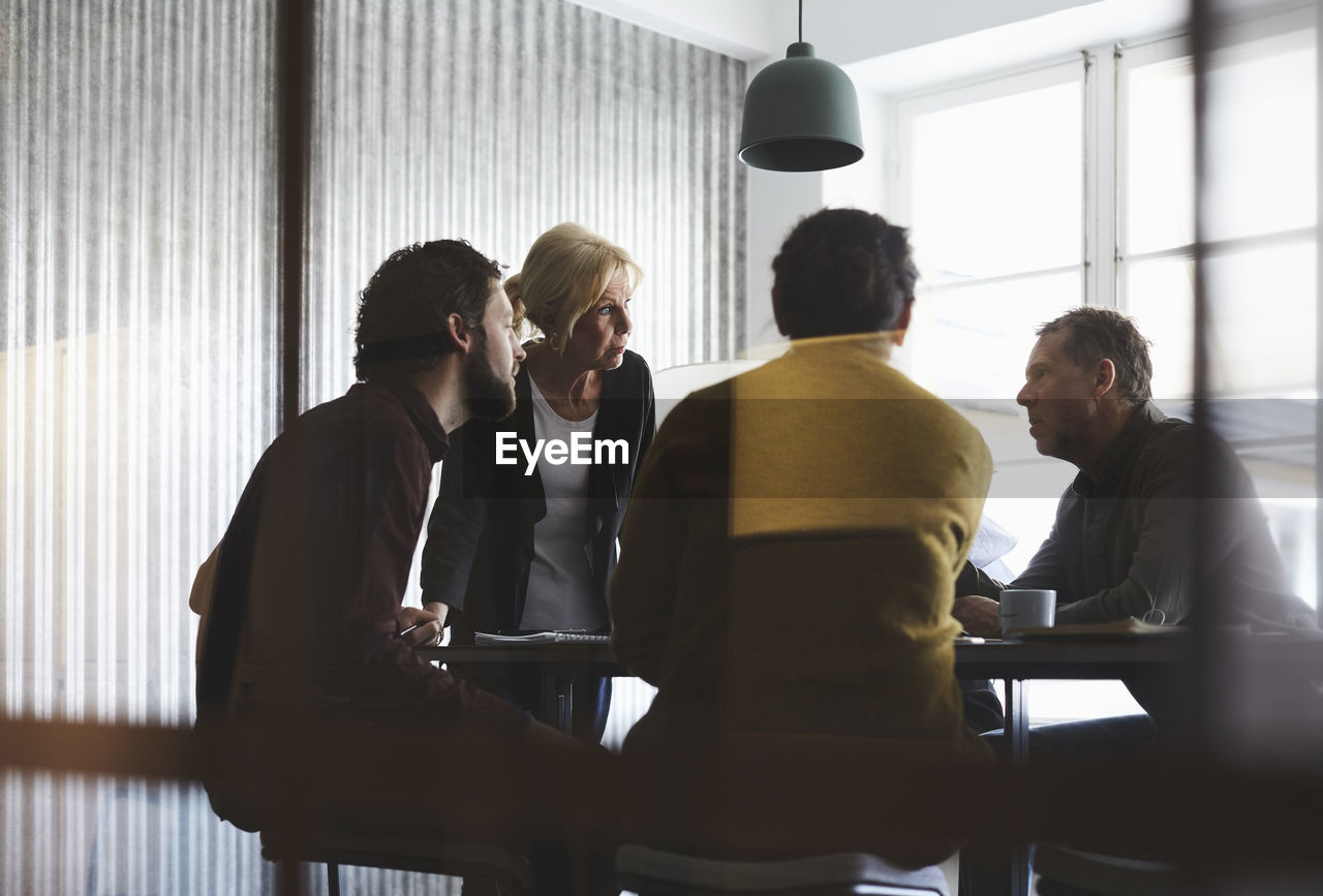 Creative business team discussing in board room at office