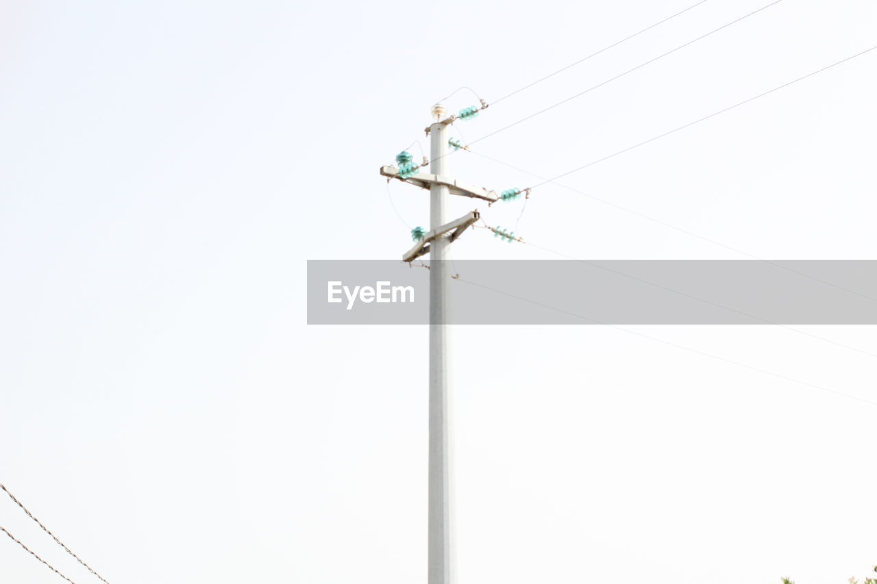 LOW ANGLE VIEW OF TELEPHONE POLE AGAINST CLEAR SKY