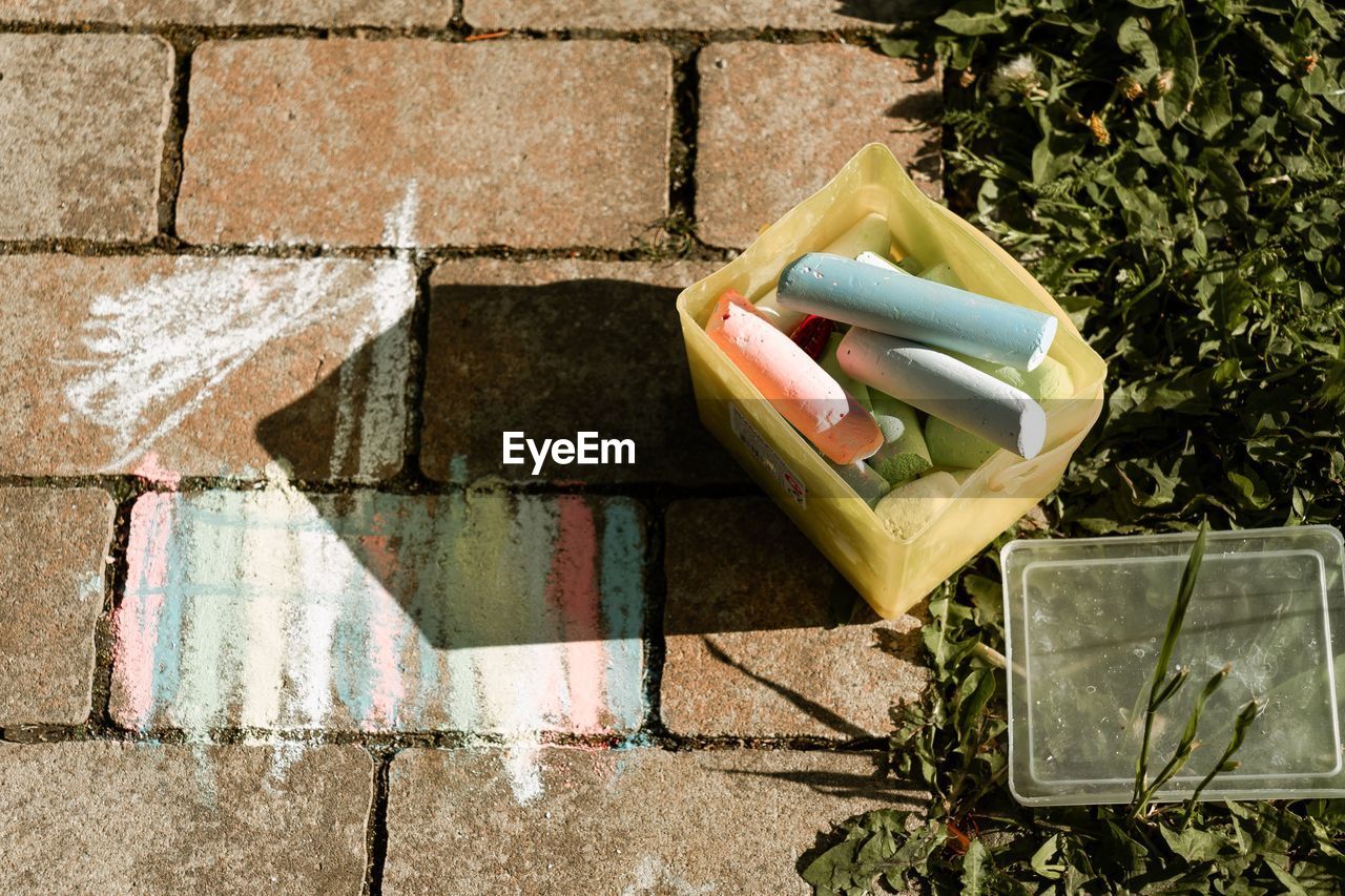 High angle view of colored chalk on pavement 