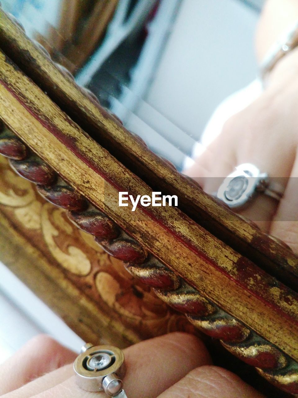 Reflection of woman with ring in mirror at home