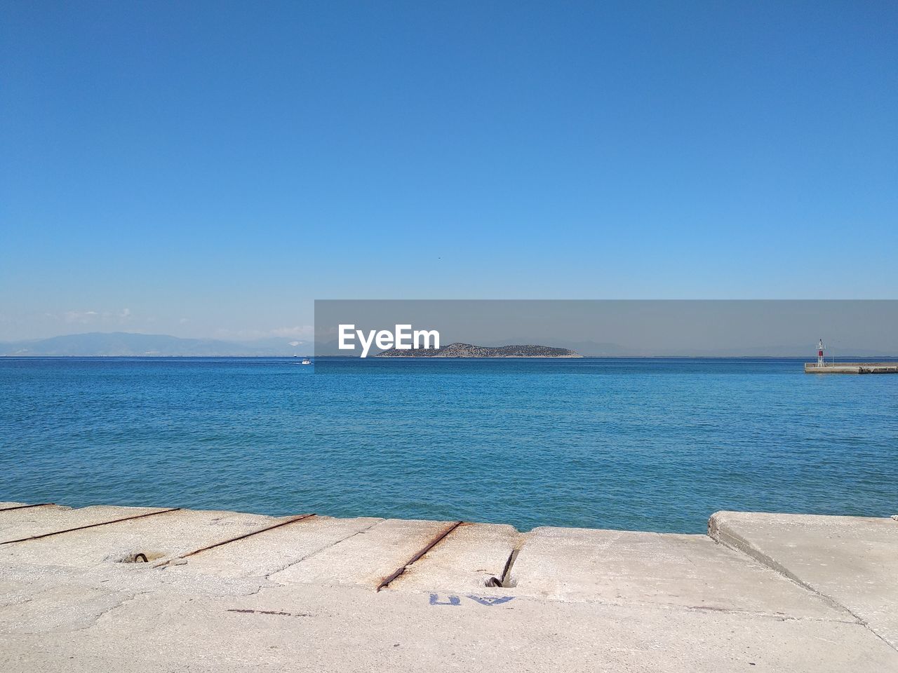 Scenic view of sea against clear blue sky
