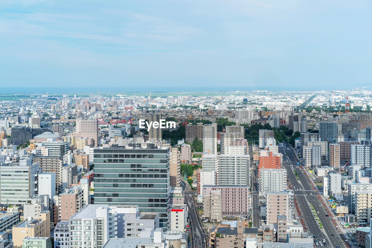 HIGH ANGLE VIEW OF BUILDINGS AGAINST SKY