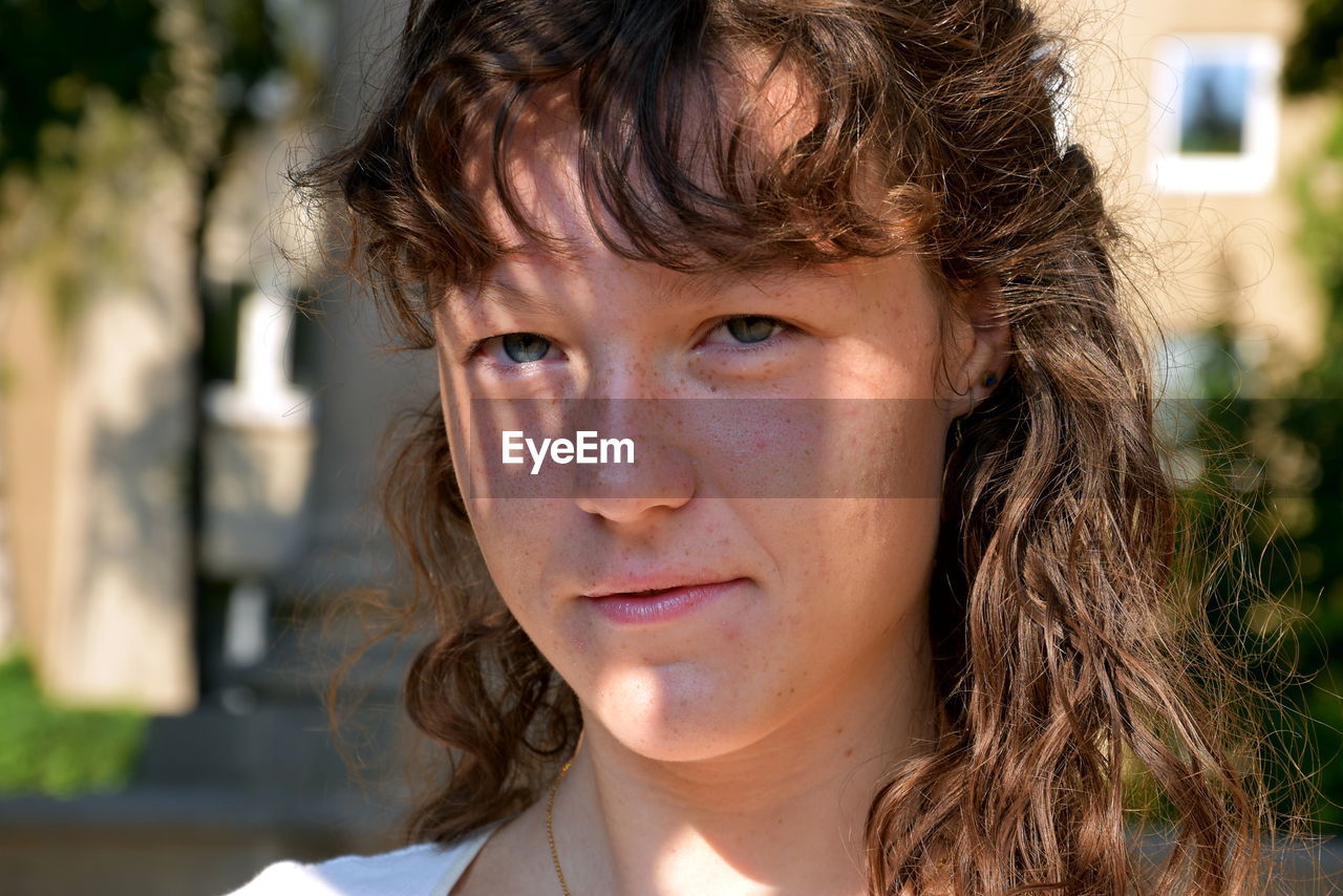 Close-up portrait of young woman with brown hair