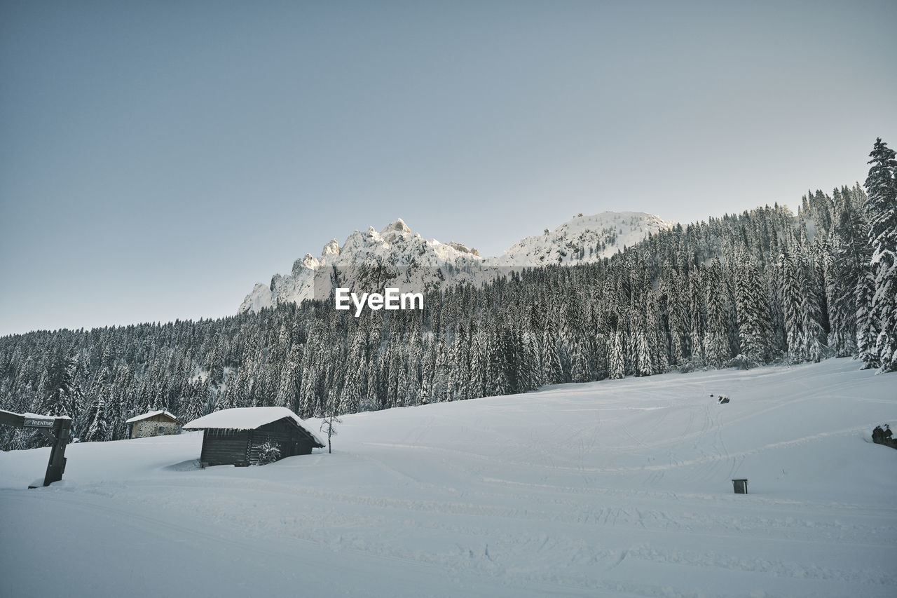 Scenic view of snow-covered mountains against clear sky