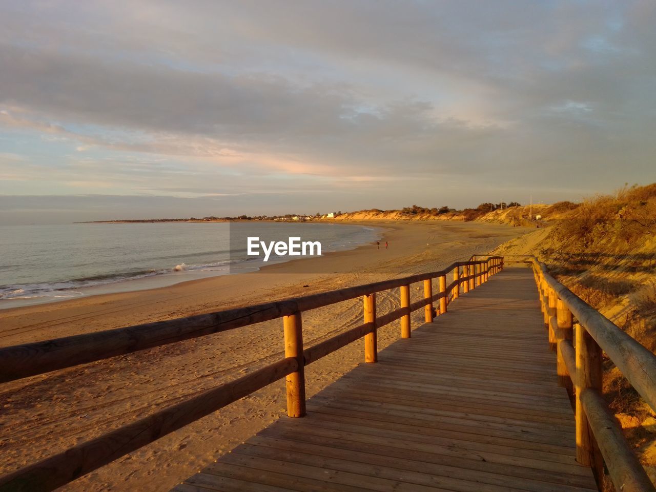 Scenic view of beach against sky during sunset