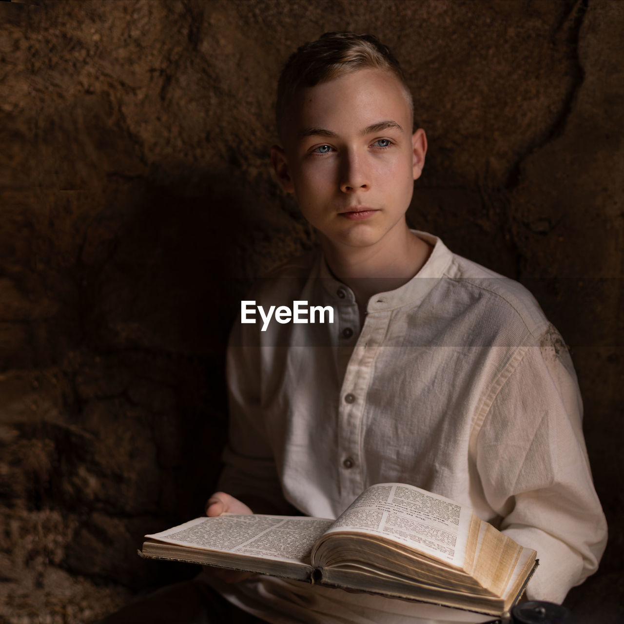 Portrait of young man reading book