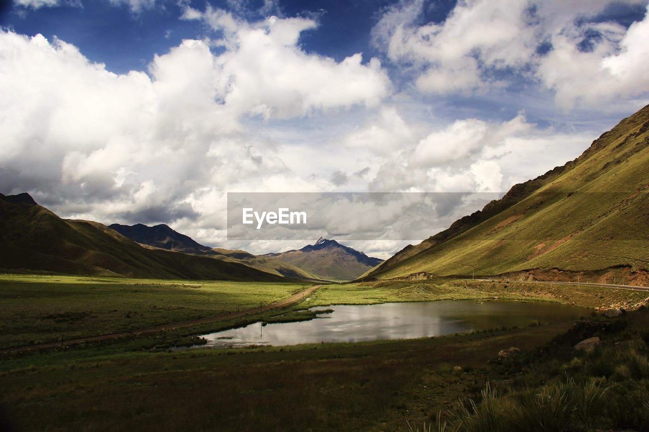 Scenic view of lake and mountains against sky