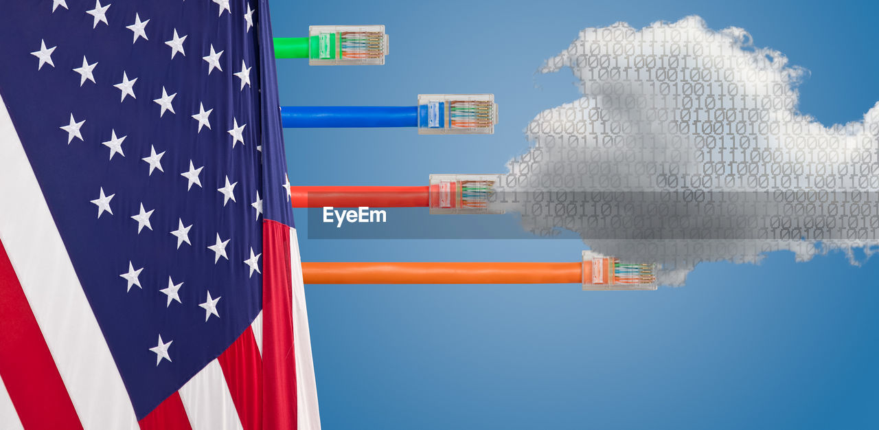 Digital composite image of american flag with multi colored cables and binary codes against blue background