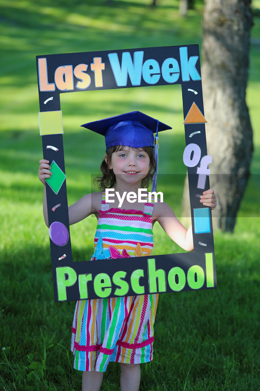 PORTRAIT OF A SMILING GIRL IN A FIELD