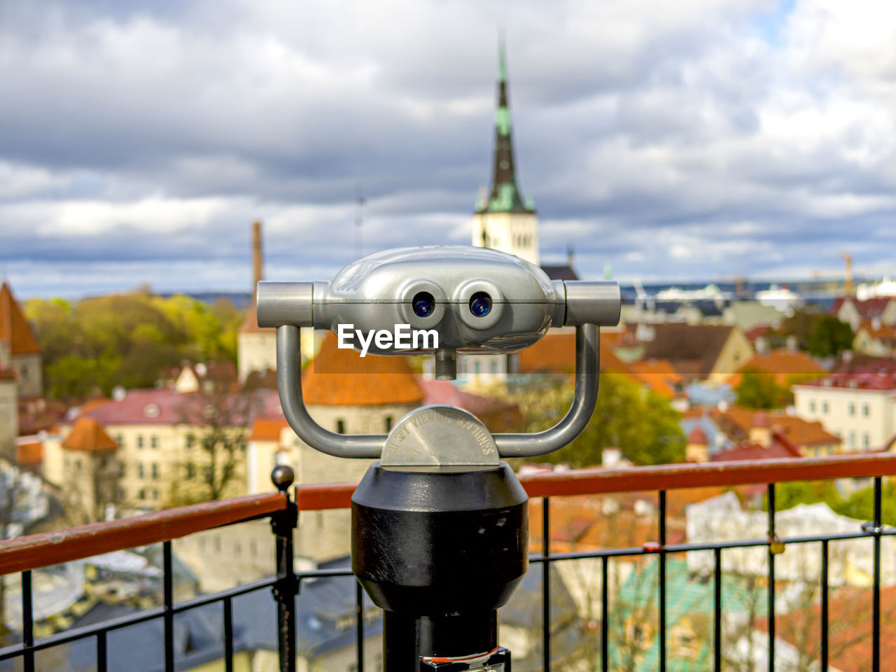 CLOSE-UP OF COIN-OPERATED BINOCULARS AGAINST SKY