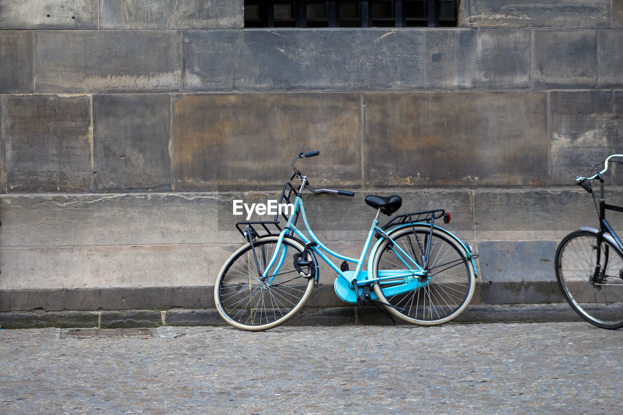 Bicycle parked against wall