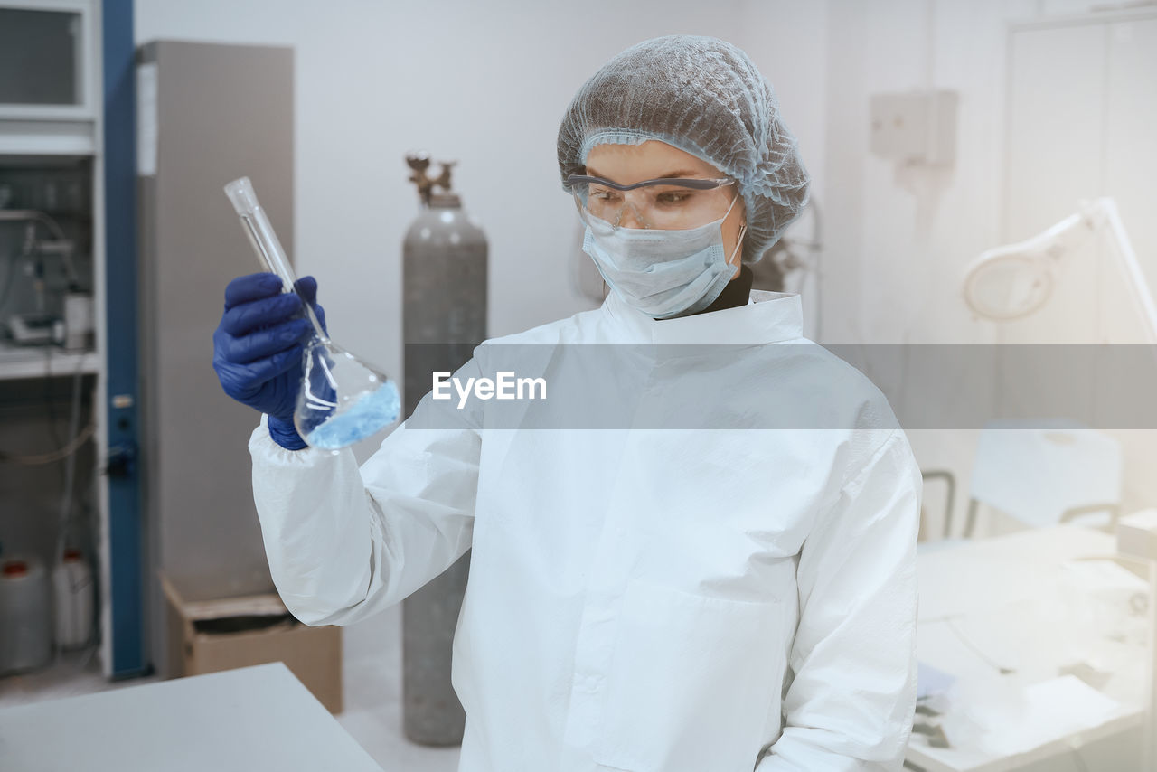 portrait of female doctor holding syringe