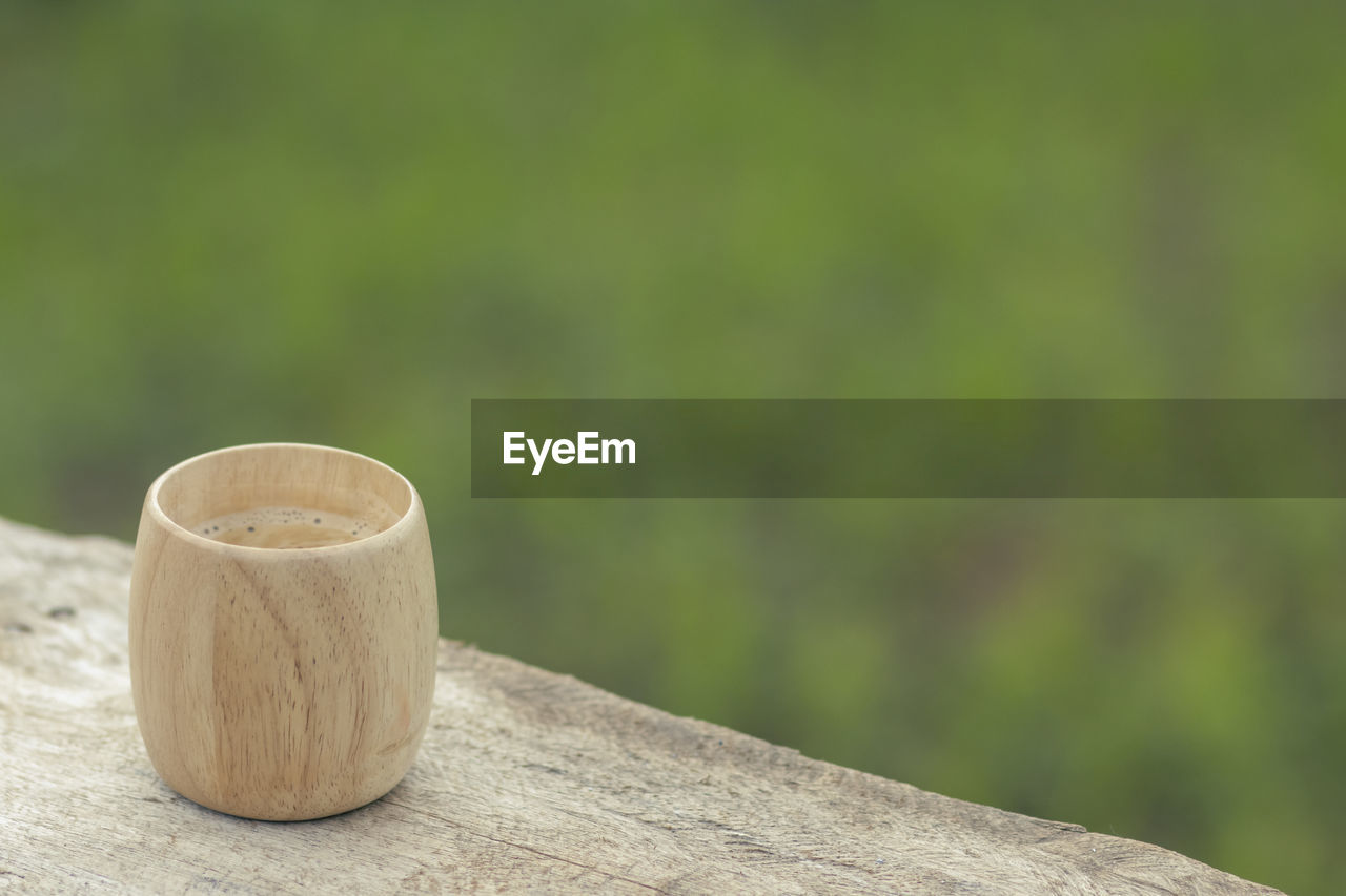 Selective focus, bamboo coffee cup, beautiful shape, placed on a wooden balcony the natural