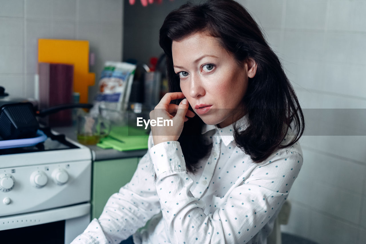 Portrait of beautiful woman sitting at home