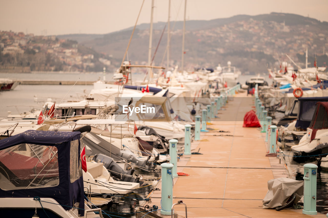 Pier amidst boats moored at port in bosphorus