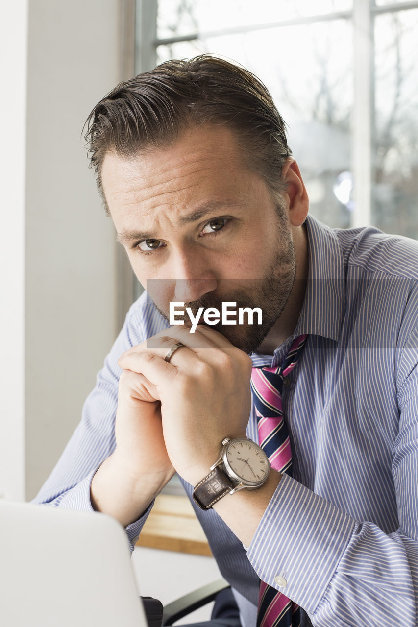 Portrait of confident mid adult businessman in office