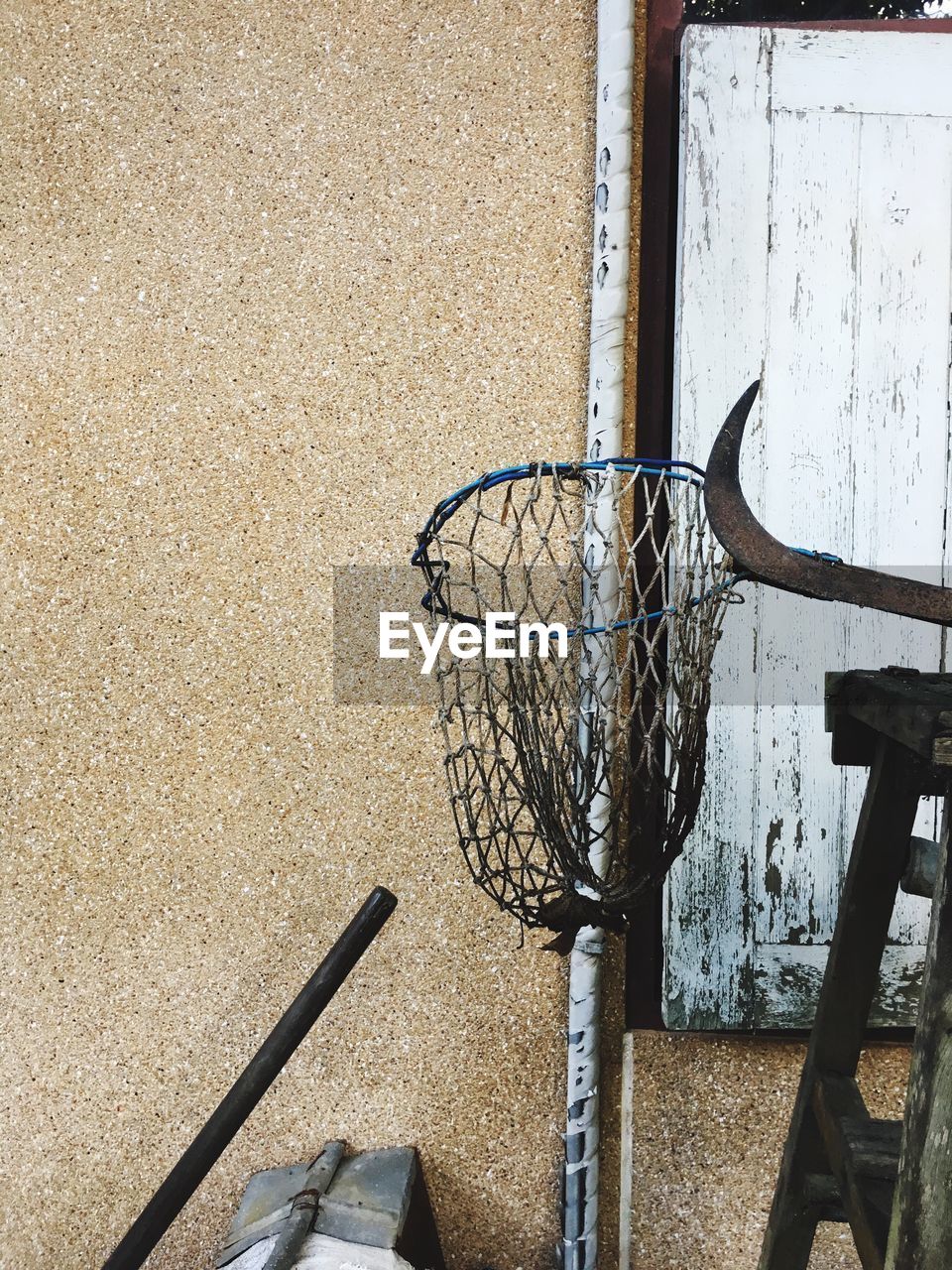 CLOSE-UP OF BASKETBALL HOOP AGAINST THE WALL