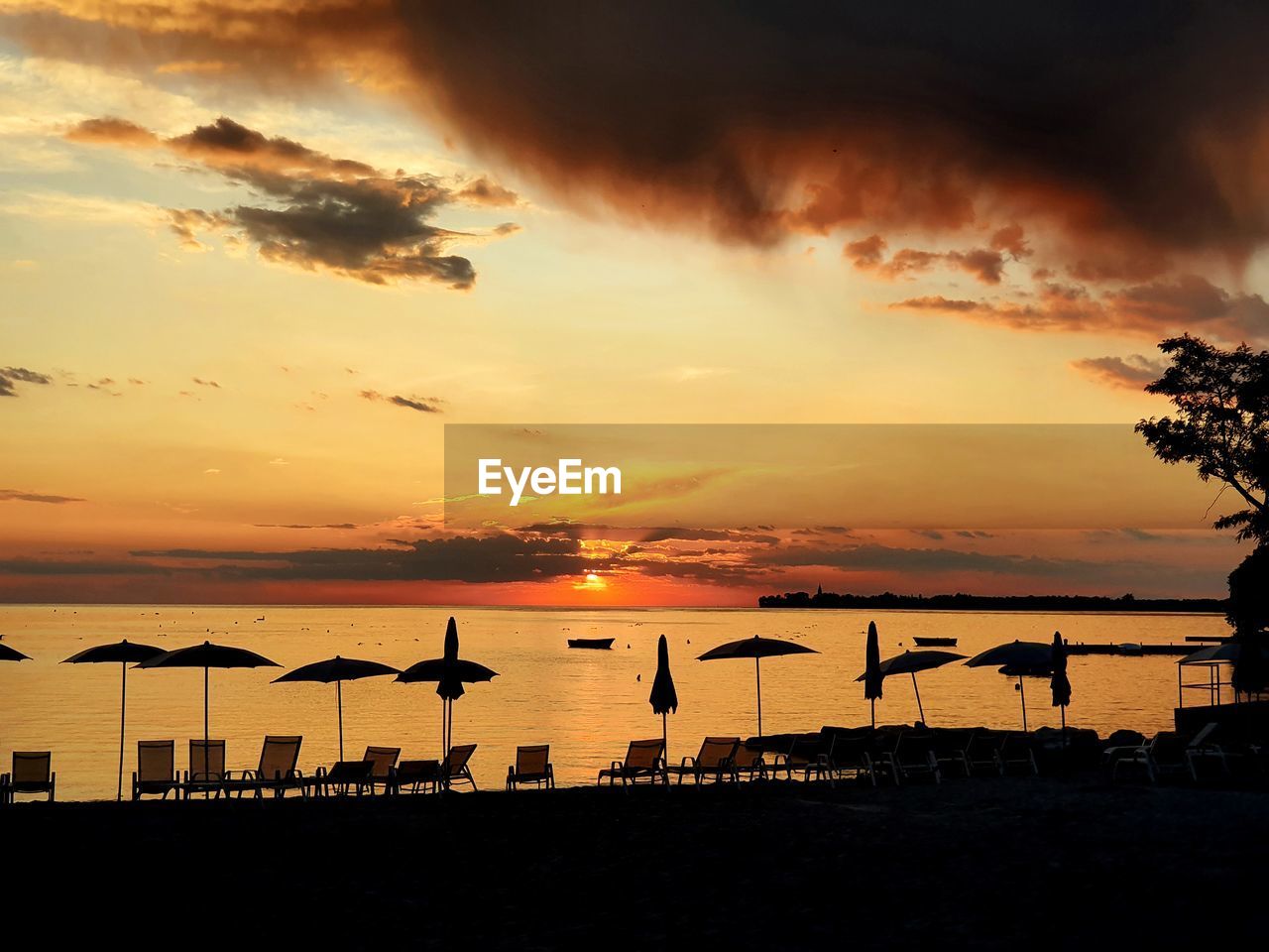 Scenic view of beach against sky during sunset