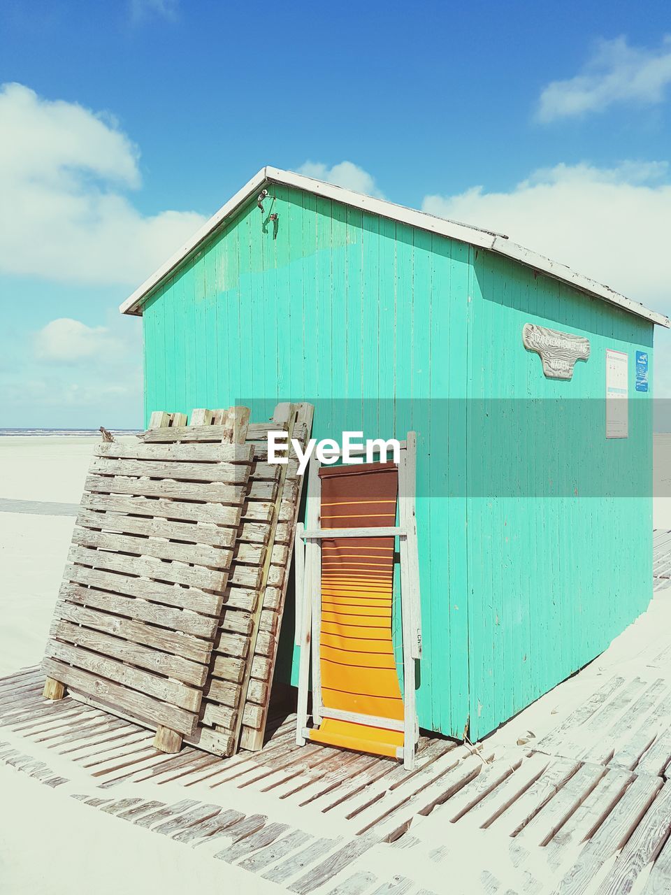 Hut at beach against sky