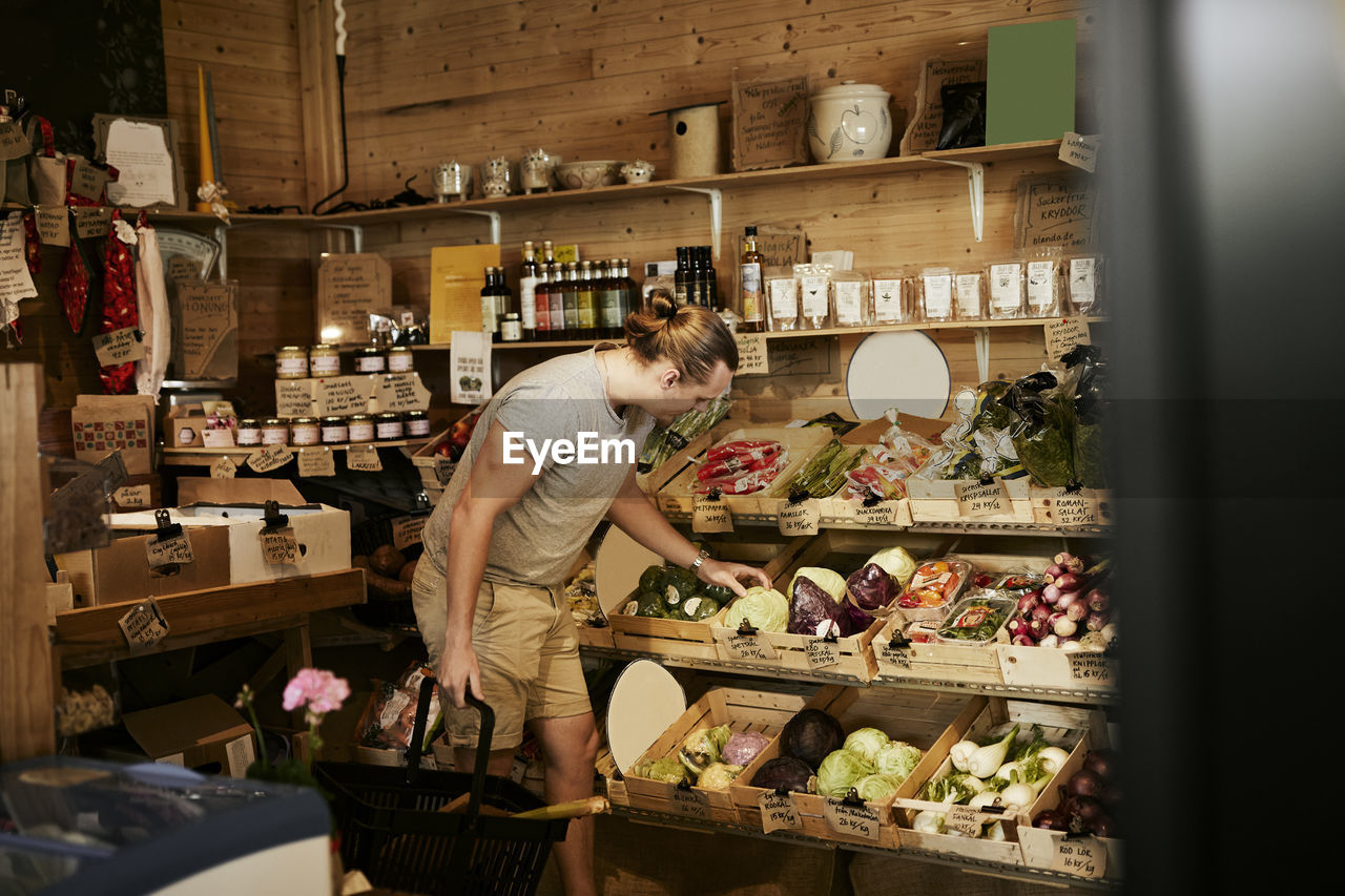 Man doing shopping in shop with organic food