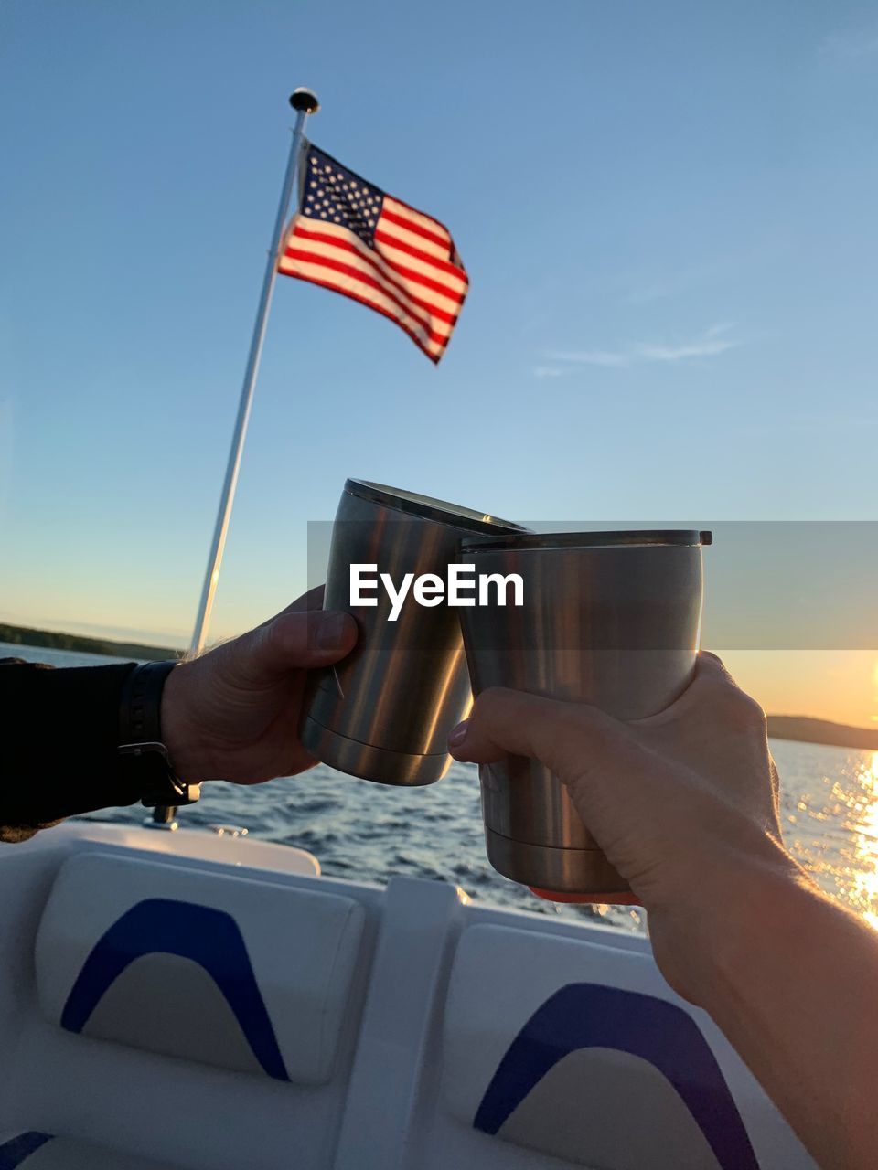 LOW ANGLE VIEW OF HAND HOLDING FLAG