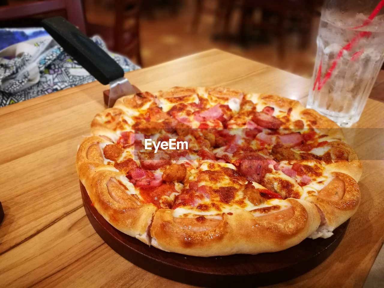 CLOSE-UP OF PIZZA WITH BREAD ON TABLE