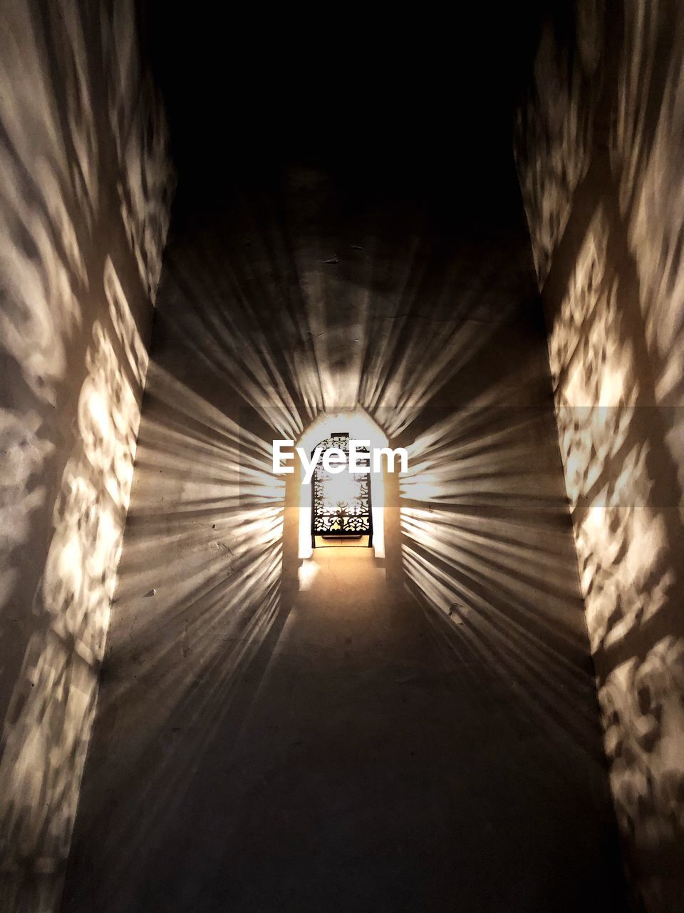 INTERIOR OF ILLUMINATED TUNNEL WITH BUILDING