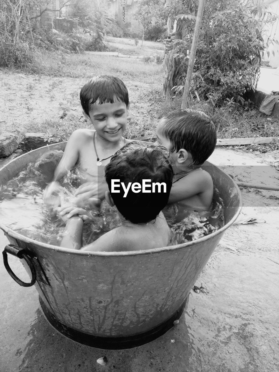 High angle view of boys playing in bathtub