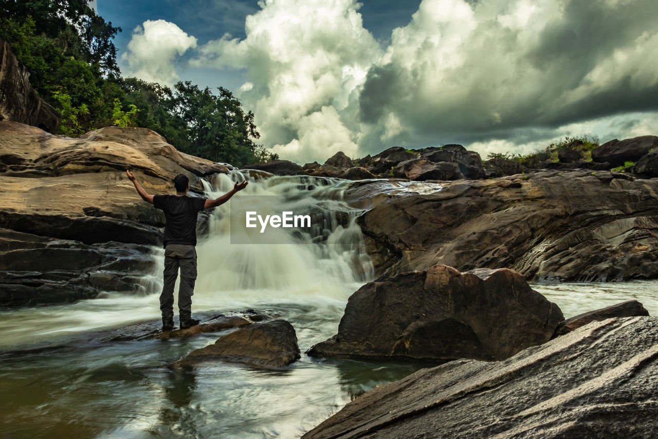 Scenic view of waterfall against rocks