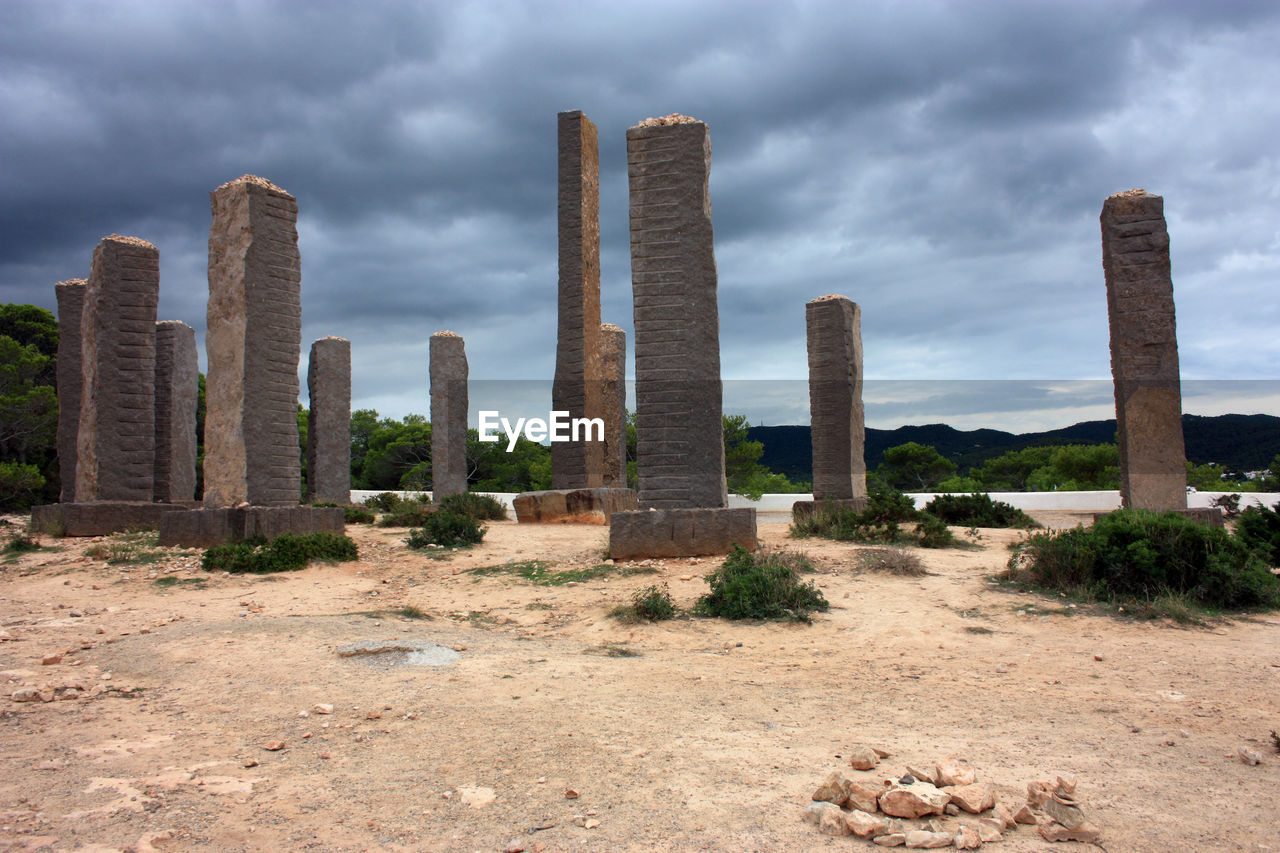 ruins, cloud, architecture, sky, landmark, landscape, nature, built structure, ancient history, history, rock, environment, travel destinations, the past, land, desert, city, no people, travel, building exterior, dramatic sky, building, plant, scenics - nature, ancient, old ruin, outdoors, monument, overcast, climate, storm cloud, business finance and industry