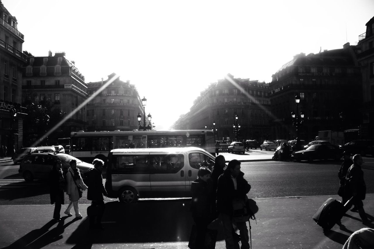 PEOPLE WALKING ON ROAD IN CITY